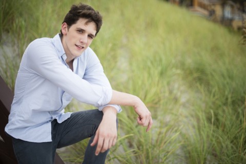 Hispanic man standing in tall grass