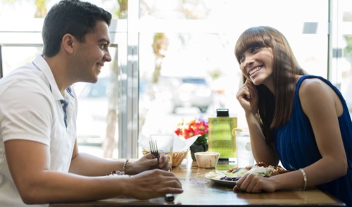 Hispanic couple eating together at cafe