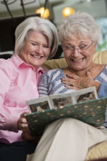 Senior Caucasian women looking at photo album