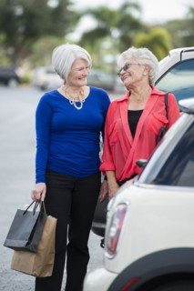 Senior Caucasian women with shopping bags in parking lot