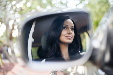 Hispanic woman driving car