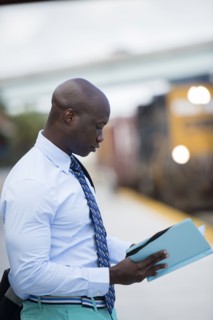 African American businessman waiting for train