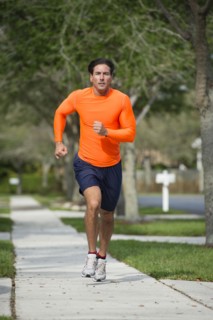 Caucasian man jogging on suburban street