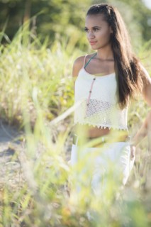 Mixed race woman walking in tall grass
