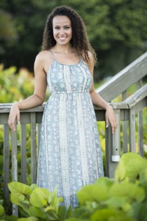 Mixed race woman leaning on wooden banister