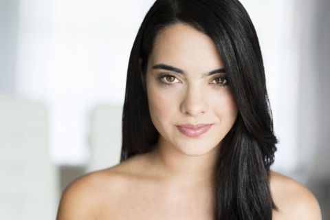 Hispanic woman with long hair smiling