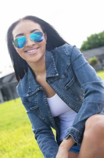 Close up of Black woman in sunglasses smiling