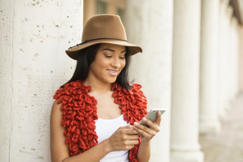 Black woman using cell phone outdoors