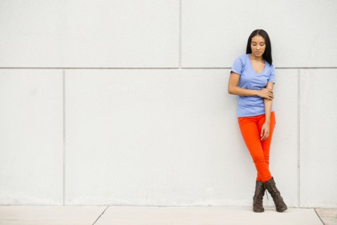 Black woman standing near concrete wall