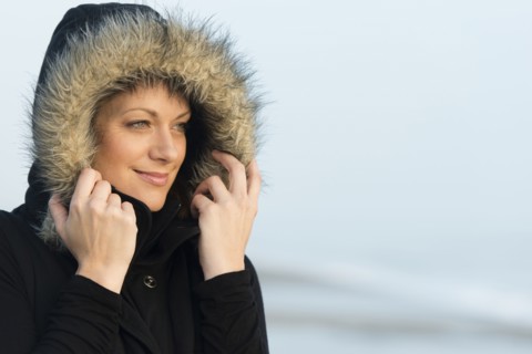 Caucasian woman wearing coat with fur hood outdoors