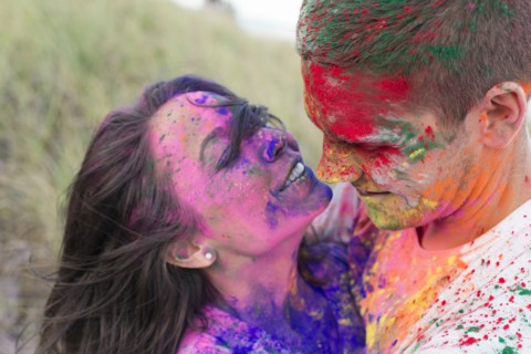 Caucasian couple splattered with paint powder