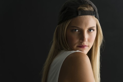 Serious Caucasian woman looking over her shoulder