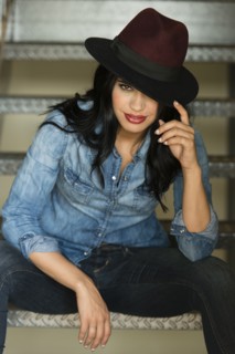 Glamorous Hispanic woman sitting on staircase