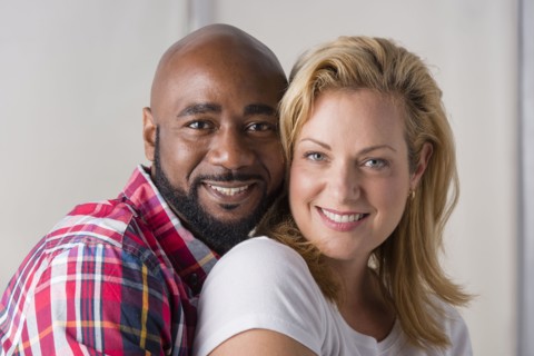 Close up of smiling couple hugging