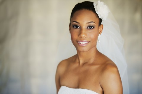 Mixed race bride wearing wedding gown and veil