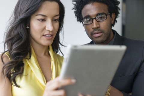 Hispanic business people using digital tablet