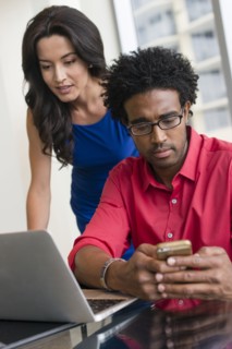 Hispanic business people working at office desk