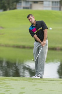 Caucasian man chipping on golf course