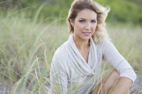 Caucasian woman sitting on beach