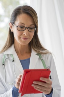 Caucasian doctor using digital tablet