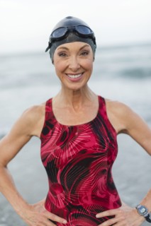 Caucasian swimmer smiling on beach