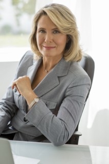 Caucasian businesswoman smiling at desk