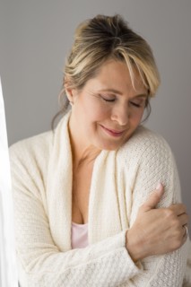 Caucasian woman wrapped in warm sweater