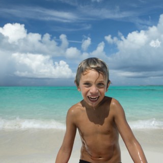 Hispanic boy playing on beach