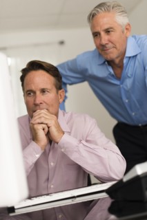 Caucasian businessmen working at computer