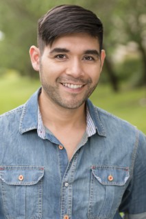 Hispanic man smiling outdoors