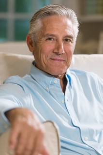 Caucasian businessman smiling on sofa