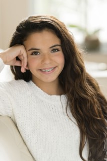 Mixed race girl smiling on sofa