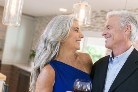 Caucasian couple drinking wine in kitchen