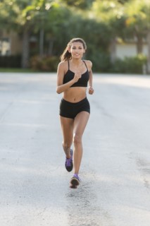 Mixed race teenage girl running outdoors