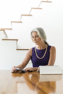 Caucasian woman using digital tablet and cell phone
