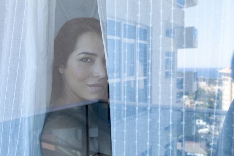 Woman looking out window