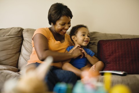 African mother playing with young son