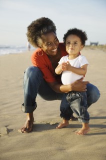 African mother on beach with son