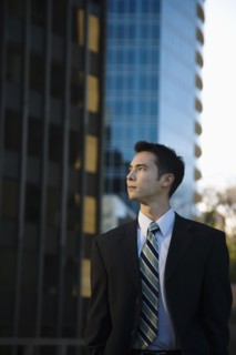 Mixed race businessman standing outdoors
