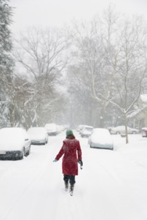 Caucasian woman walking in snow storm