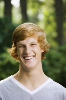Grinning red haired teenage boy