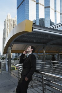 Caucasian businessman talking on cell phone outdoors