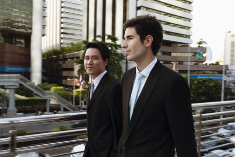 Businessmen walking together outdoors