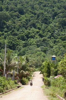 Person riding on scooter in remote Cambodian area