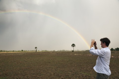 Man taking picture of rainbow
