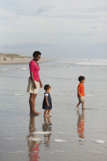 Mother and children enjoying beach together