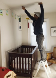 Black man decorating bedroom