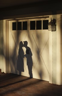 Shadow on garage of couple kissing