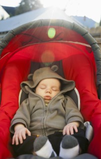 Caucasian baby sleeping in car seat