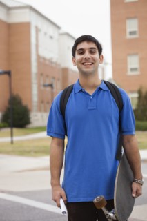 Middle Eastern student carrying skateboard